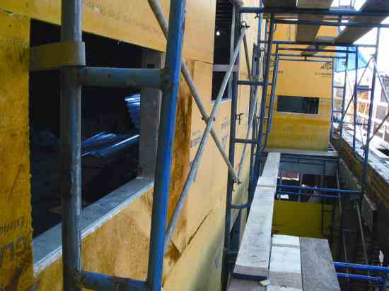 DensGlass Gold paperless gypsum sheathing now covers the building's exterior.